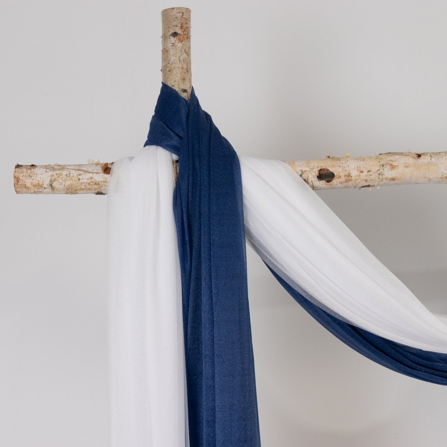 Navy blue sheer backdrop drape for wedding arch and ceiling decor.