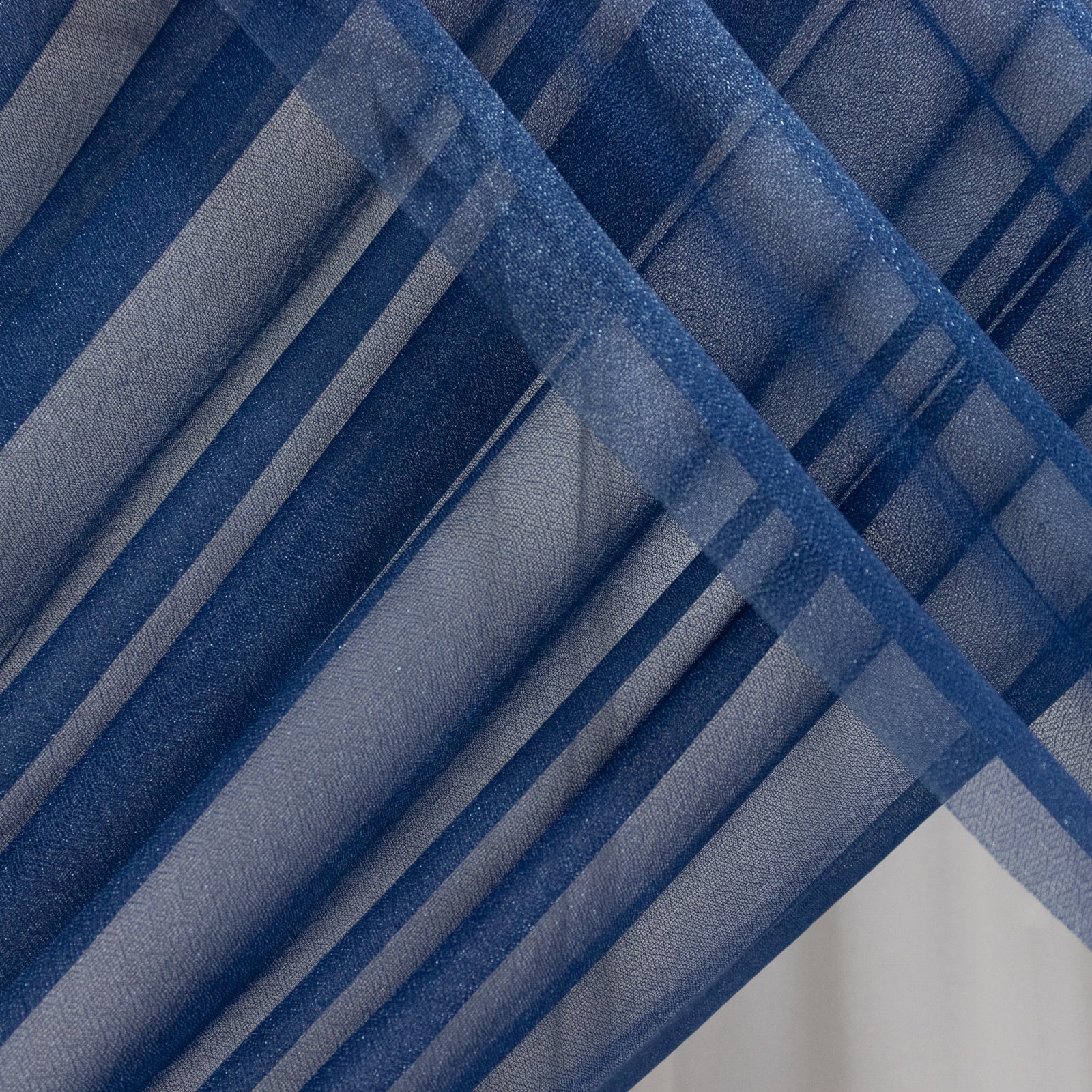 Navy blue sheer backdrop drape for wedding arch and ceiling decor.