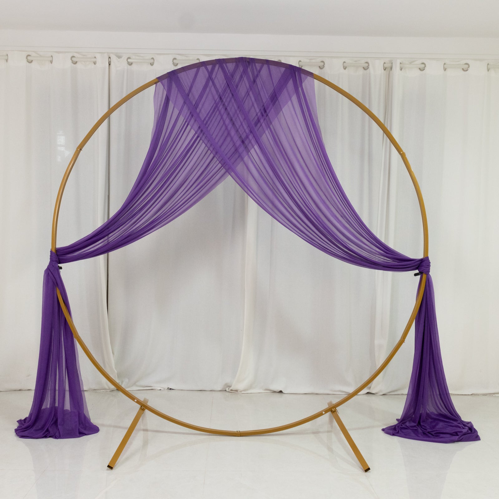 Purple sheer backdrop drape for wedding arch and ceiling decor.