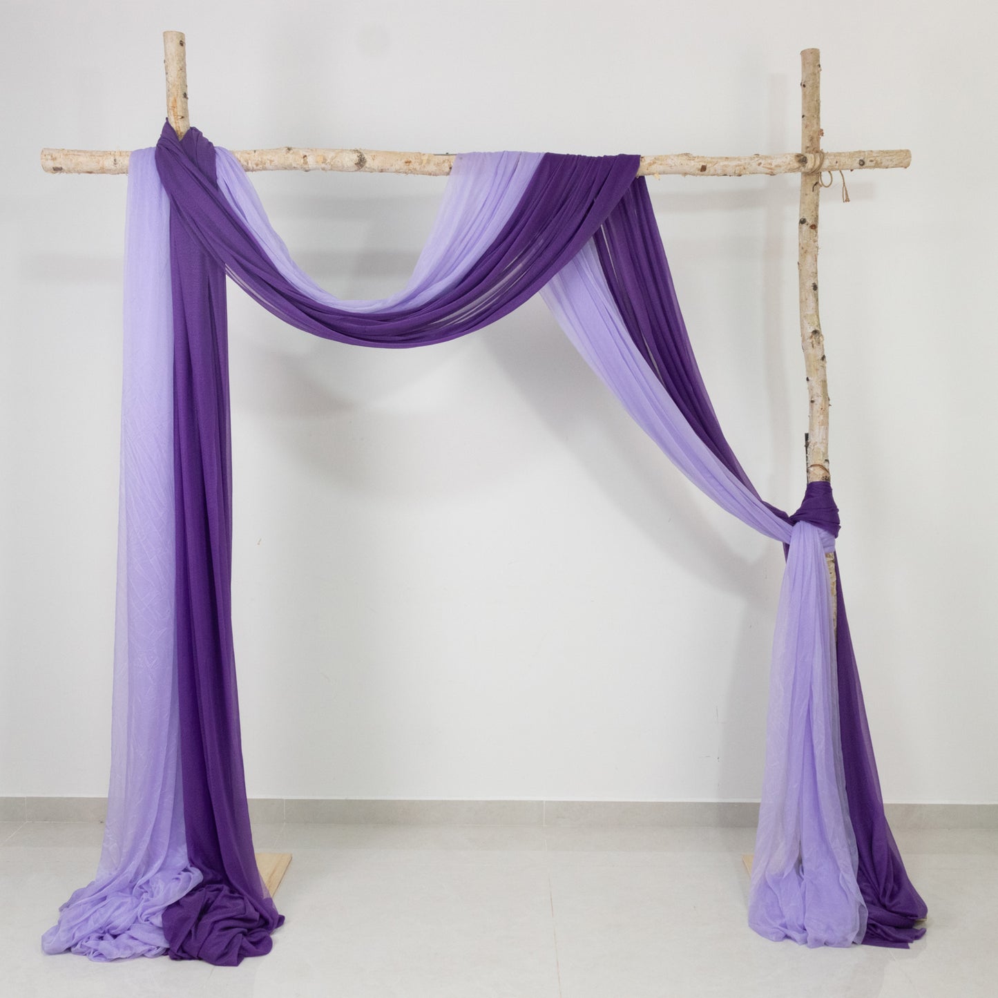 Purple sheer backdrop drape for wedding arch and ceiling decor.