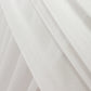 White sheer backdrop drape with soft shimmer for wedding decor.