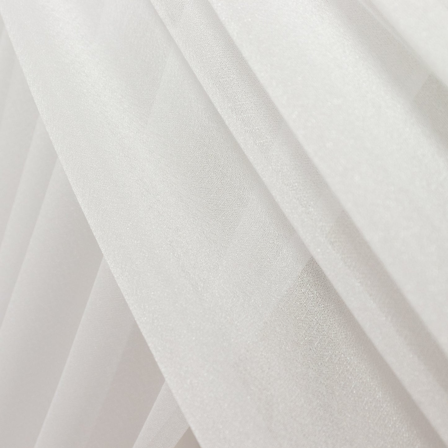 White sheer backdrop drape with soft shimmer for wedding decor.
