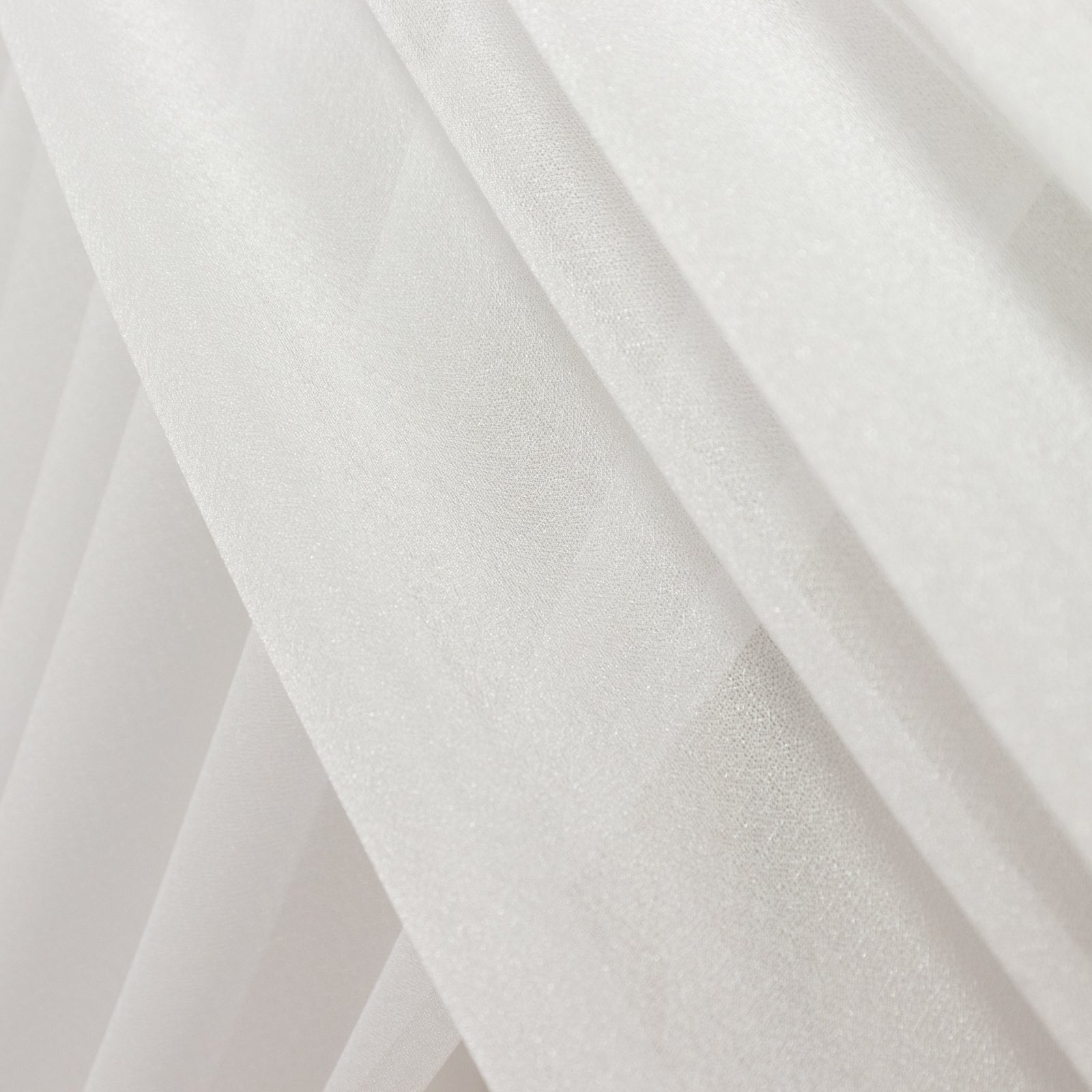 White sheer backdrop drape with soft shimmer for wedding decor.