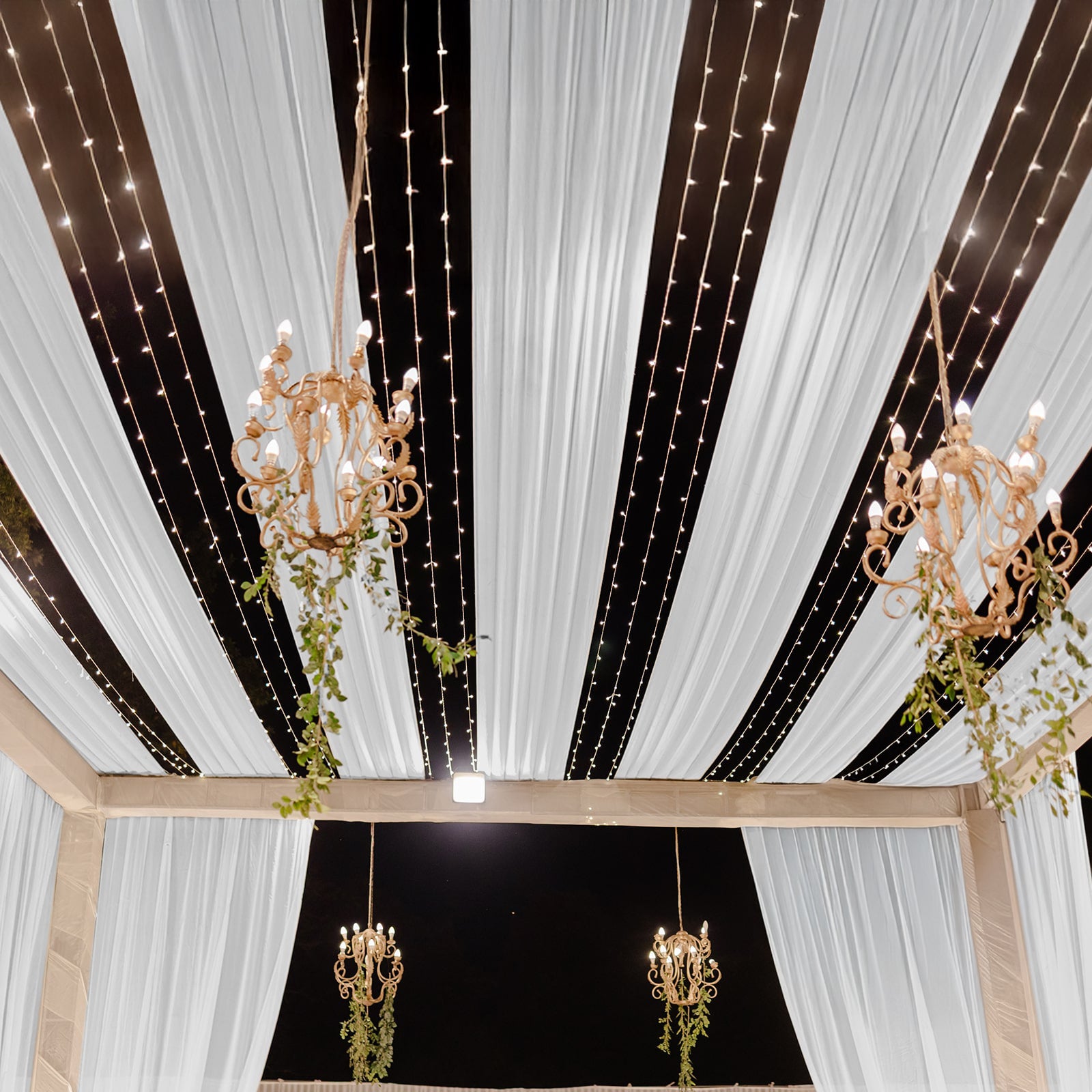 White sheer backdrop drape with soft shimmer for wedding decor.