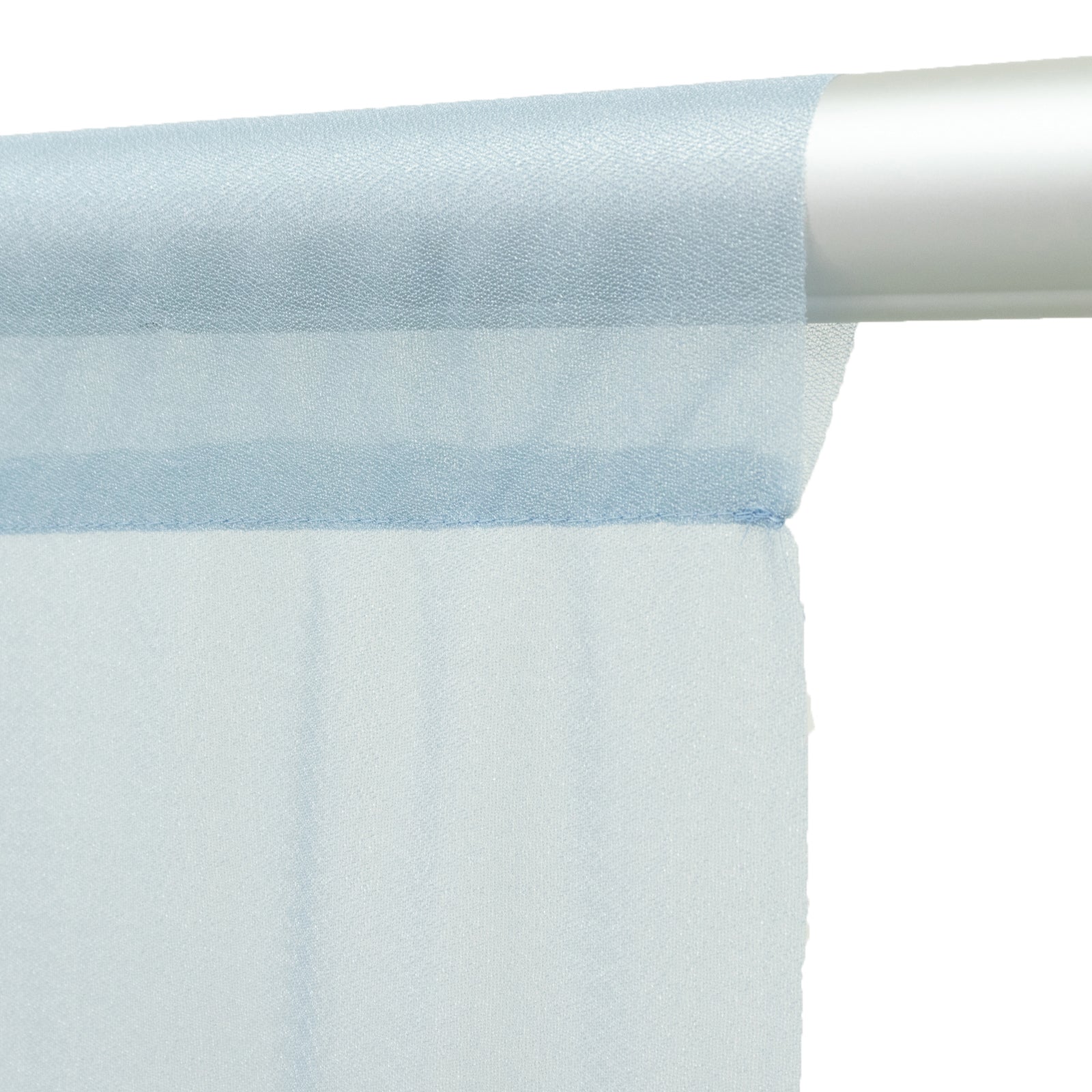 Dusty blue sheer backdrop curtain panel draped on a rod.