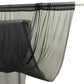 Black sheer backdrop curtain panel hanging on a rod.
