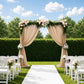 Taupe sheer backdrop curtain panel draping a wedding arch.
