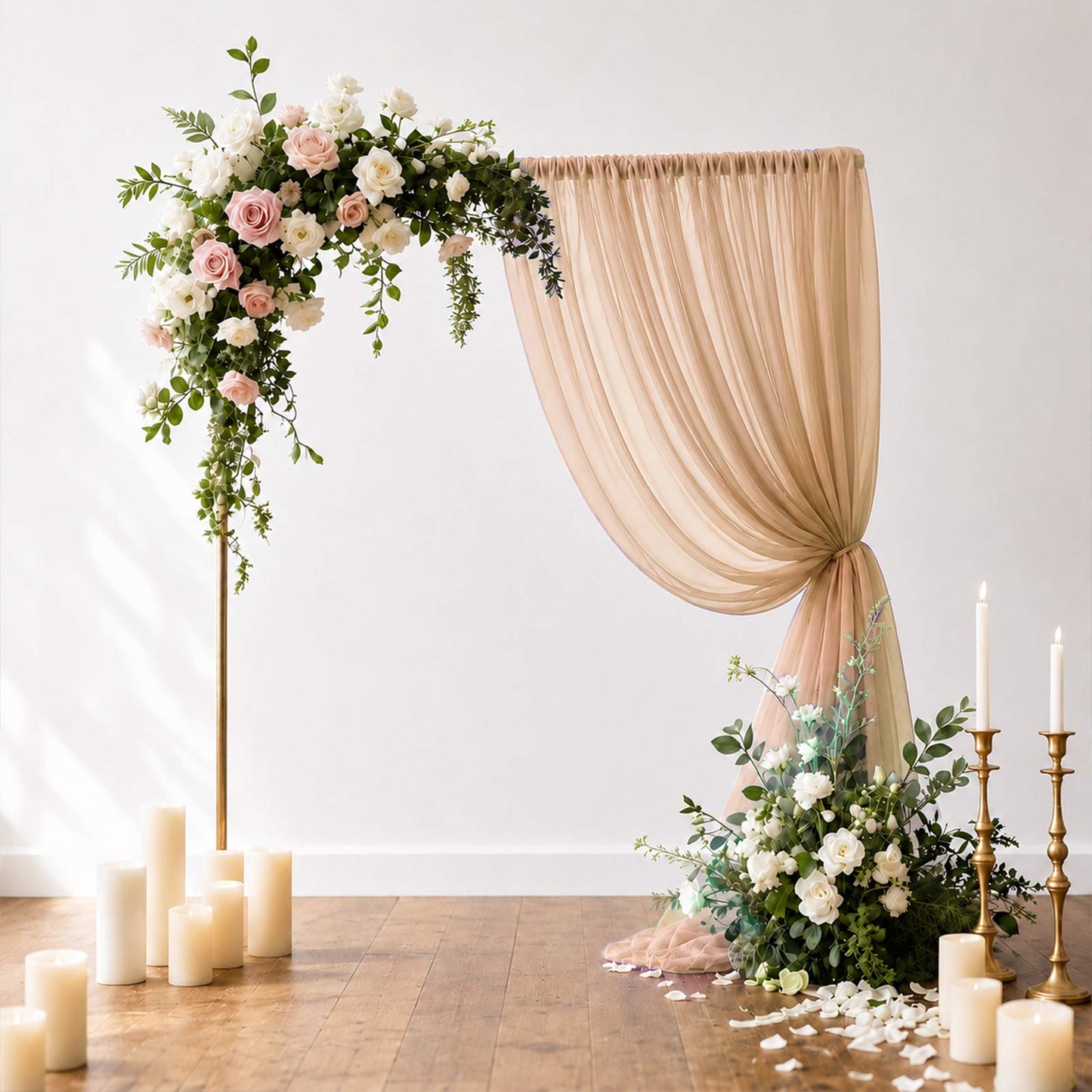 Taupe wedding arch drape curtain panel with floral decor and candles.