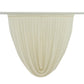 Beige sheer chiffon backdrop valance drapes with a curved swag design.