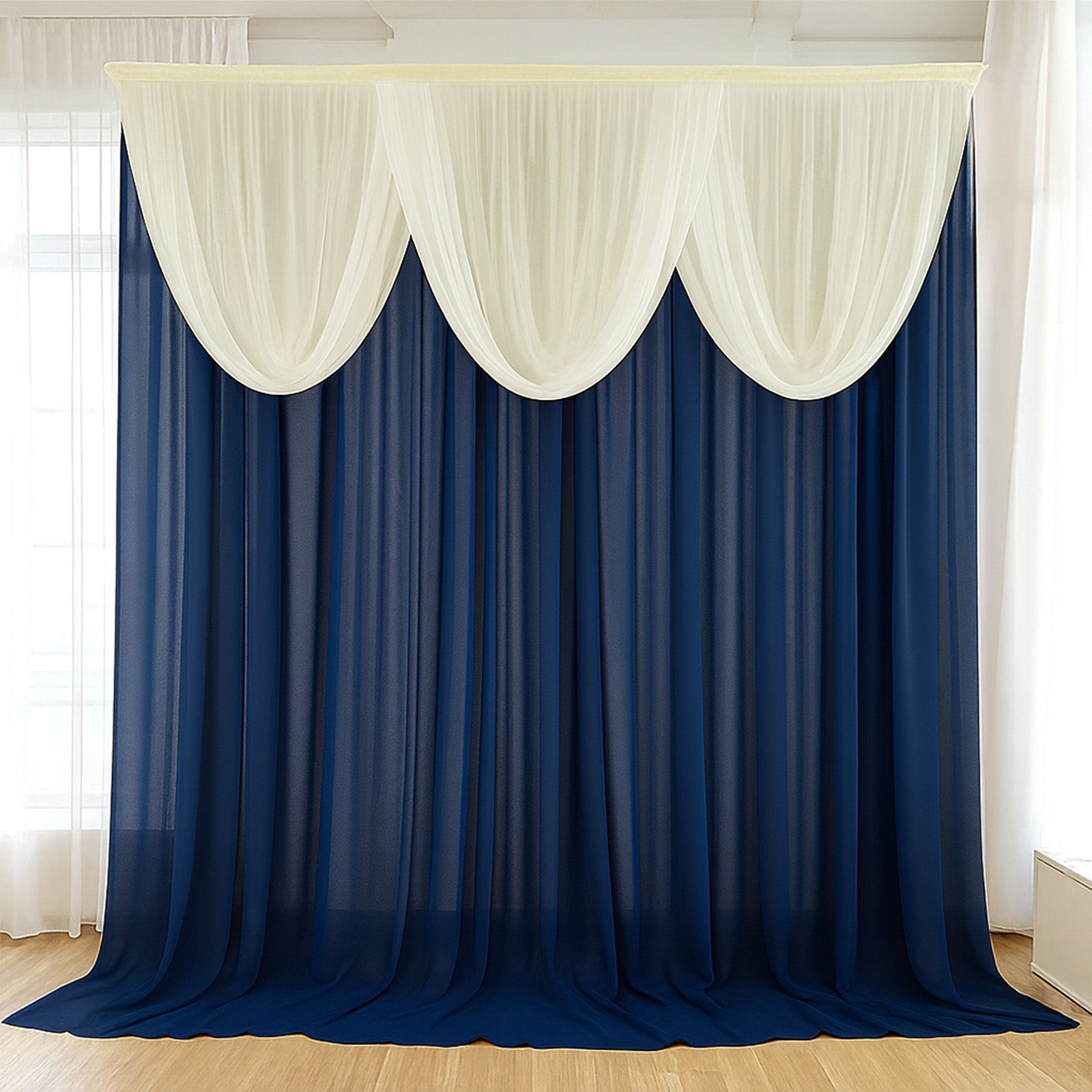 Navy blue sheer chiffon backdrop valance drapes with beige curved swag topper.