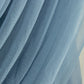 Dusty blue sheer chiffon backdrop valance drapes in a curved swag design.