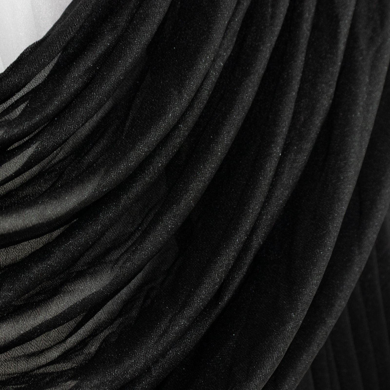 Black chiffon backdrop valance drapes with curved swag design.