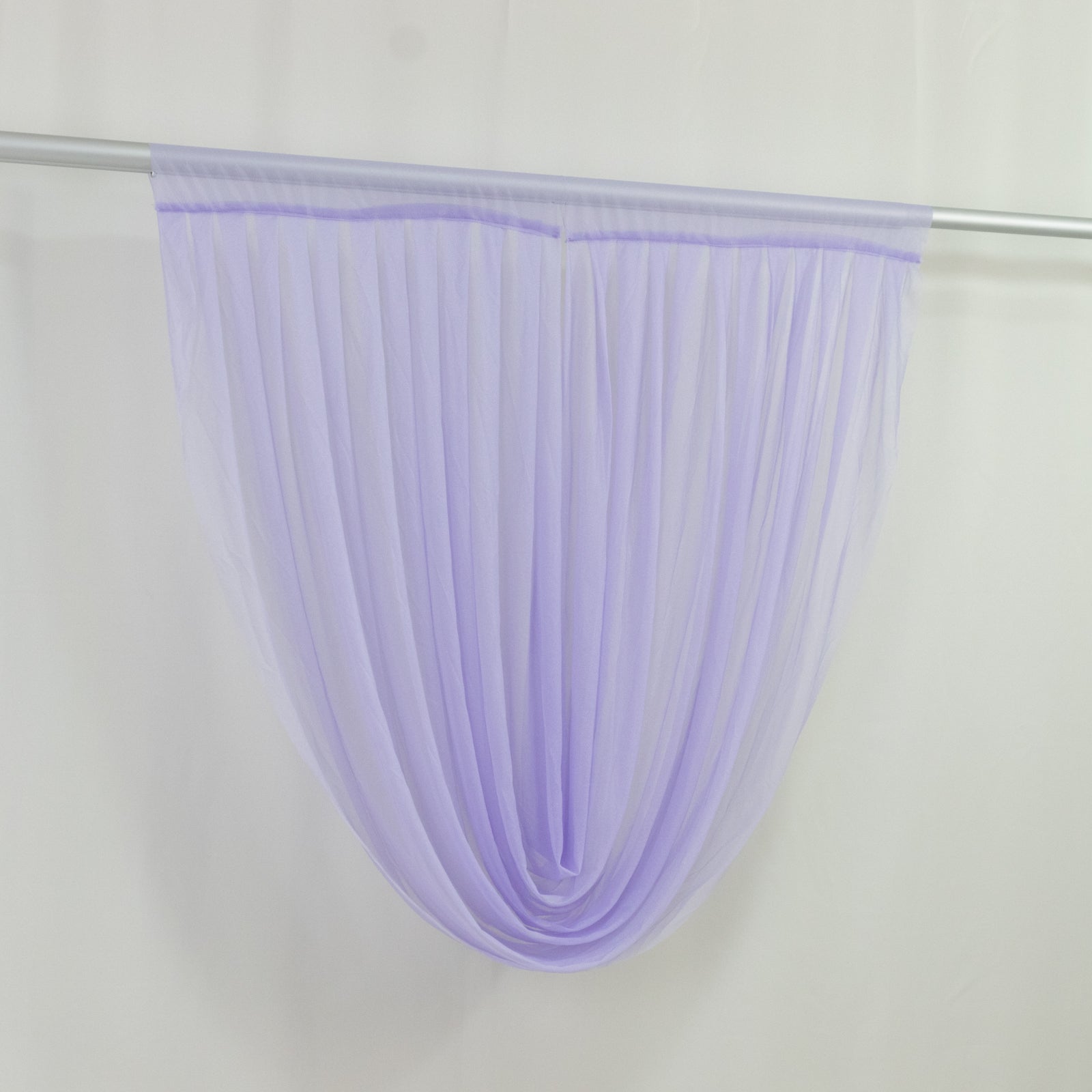 Lavender lilac sheer chiffon backdrop valance drapes hanging elegantly.