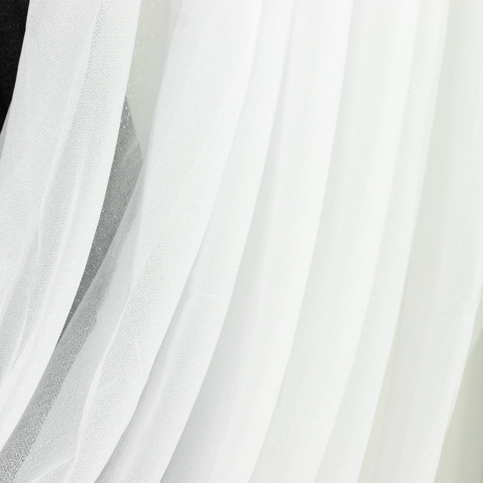 White sheer chiffon backdrop valance drapes with curved swag topper panel.