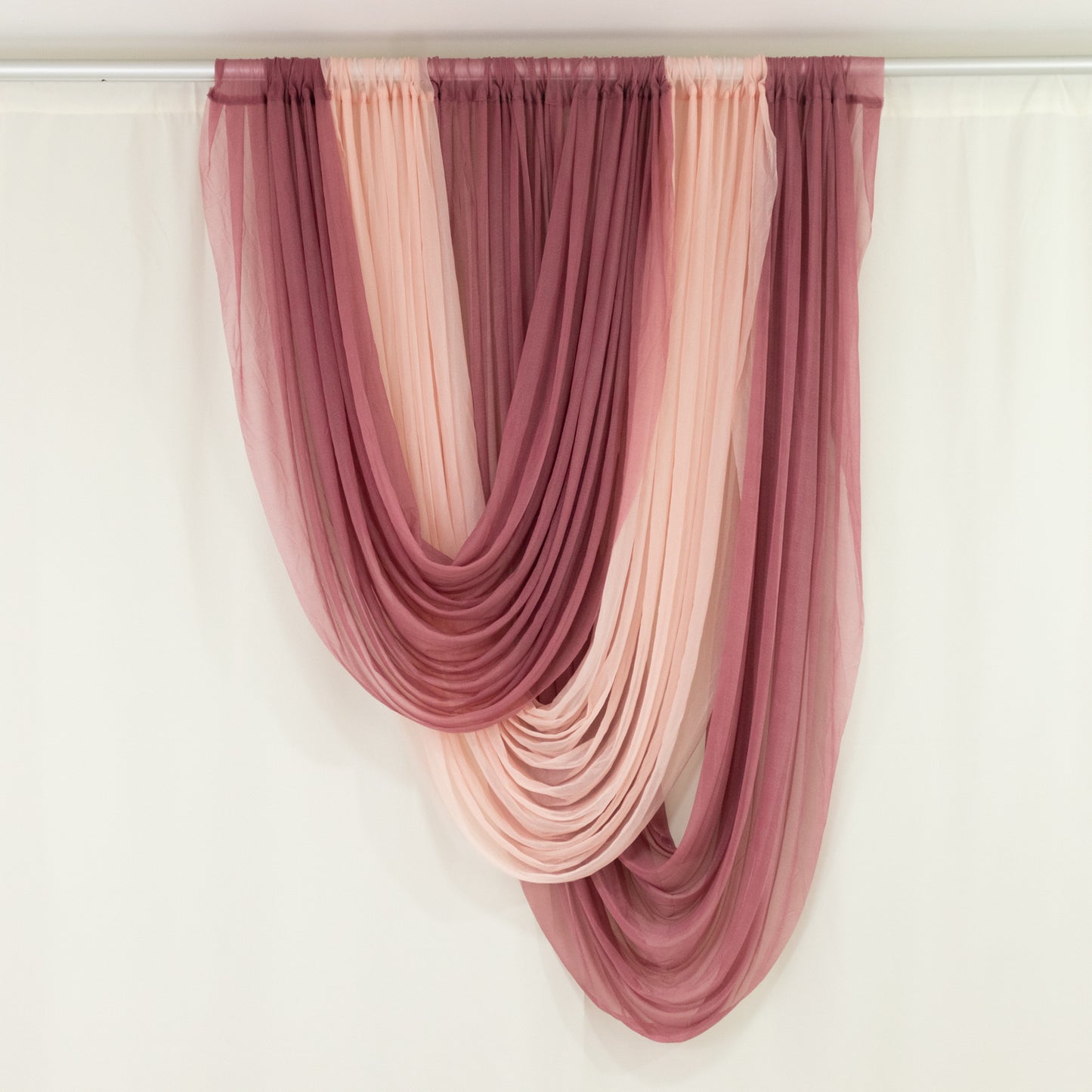 Blush sheer chiffon valance curtain draped elegantly in soft pinks and burgundy.