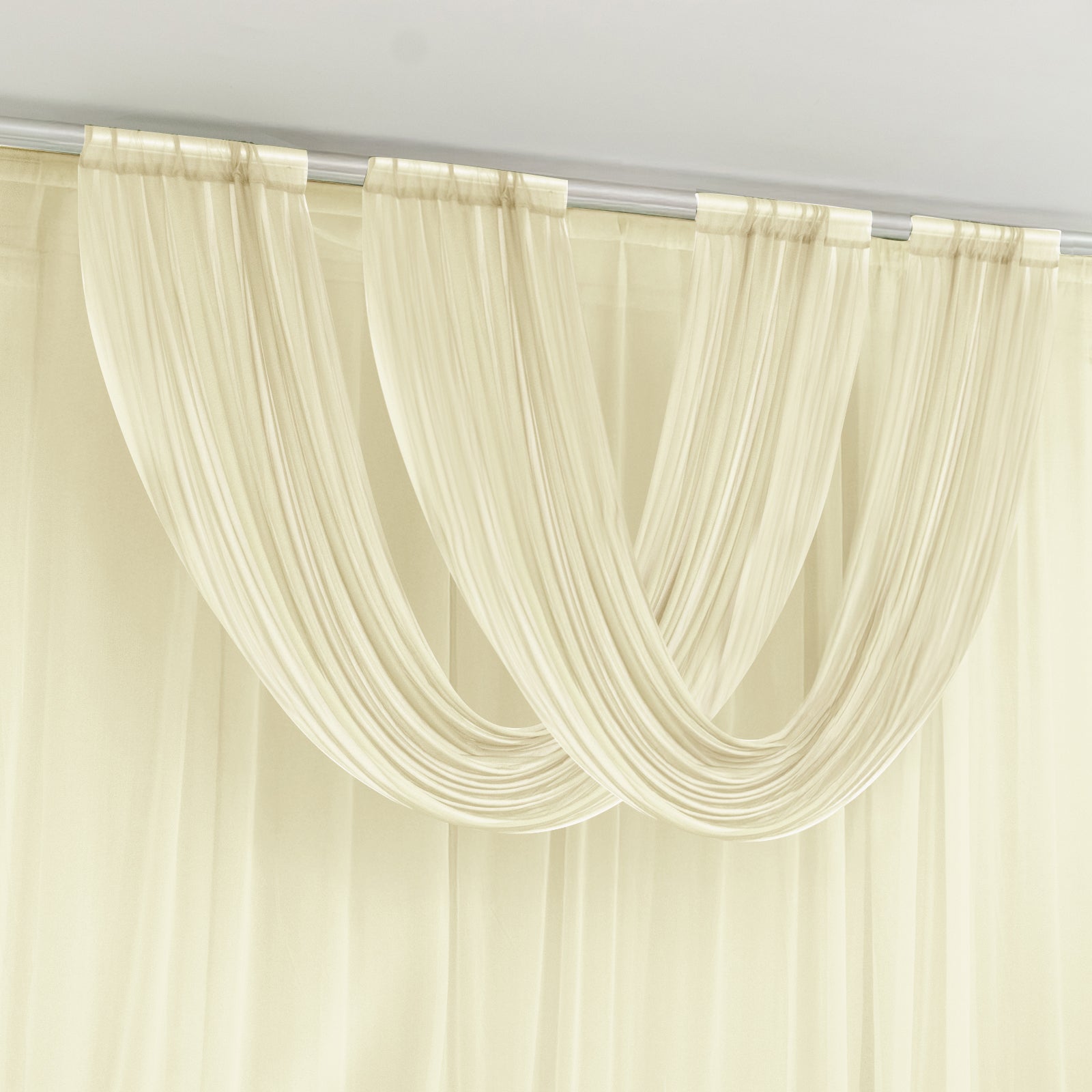 Beige sheer chiffon valance curtain draped elegantly on a rod.