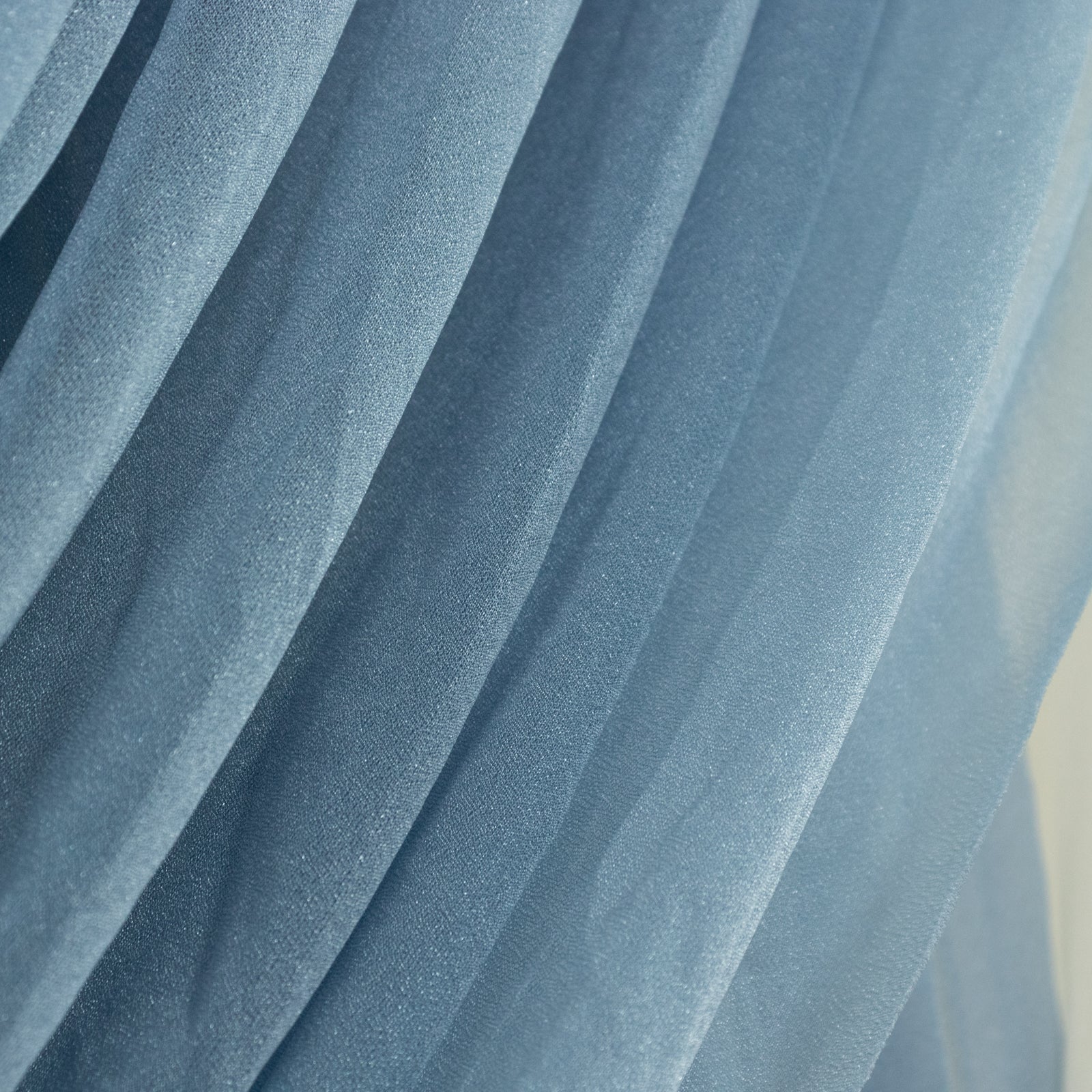 Dusty blue sheer chiffon valance curtain drape for wedding arch.