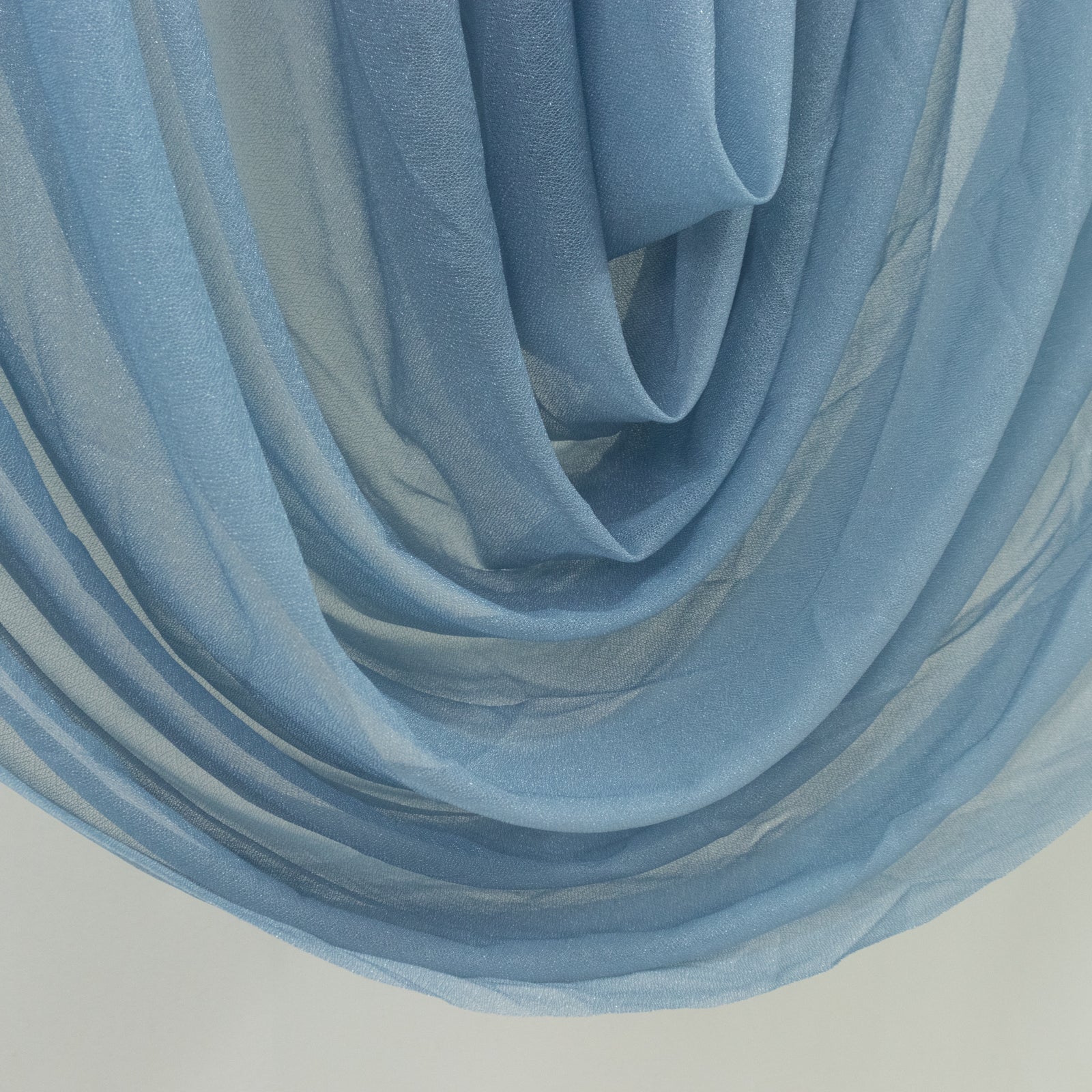 Dusty blue sheer chiffon valance curtain draping elegantly.