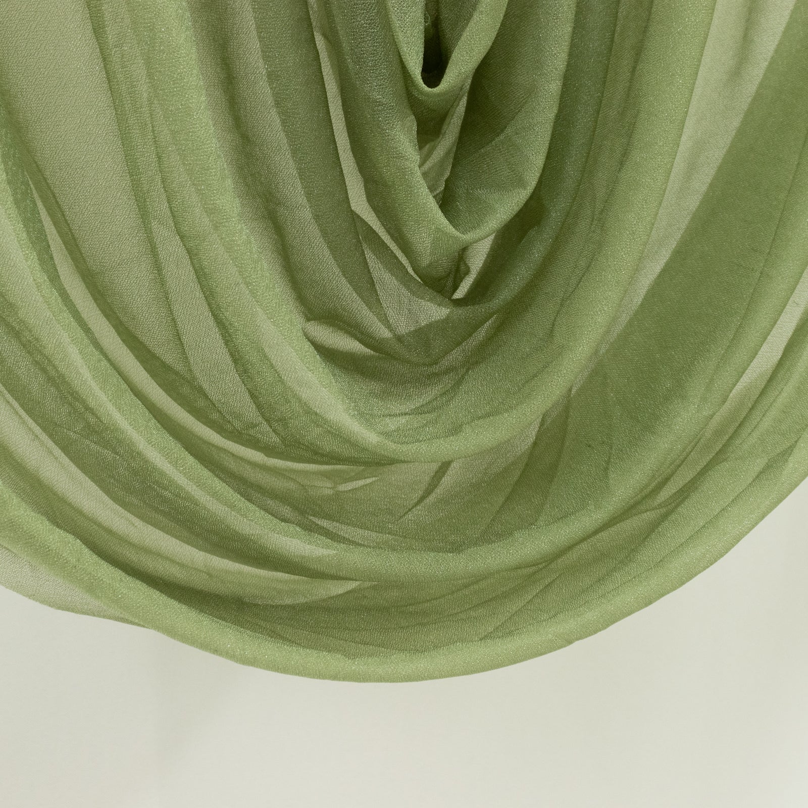 Dusty sage green sheer chiffon valance curtain draped elegantly.
