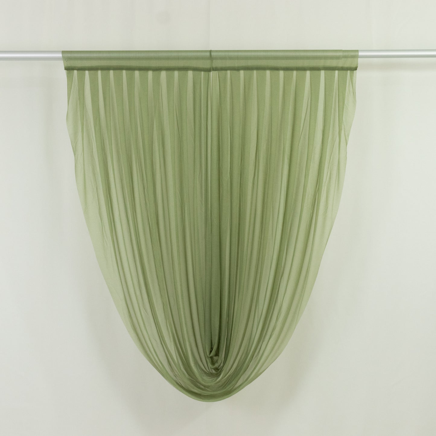 Dusty sage green sheer chiffon valance curtain draped elegantly.