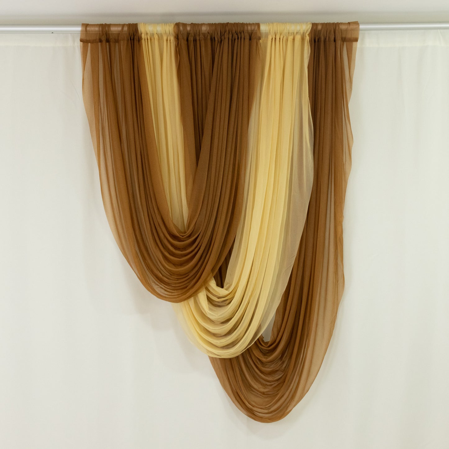 Gold sheer chiffon valance curtain draped elegantly.