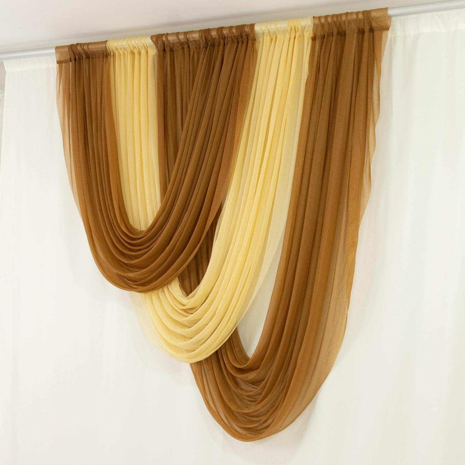 Gold sheer chiffon valance curtain draped elegantly.