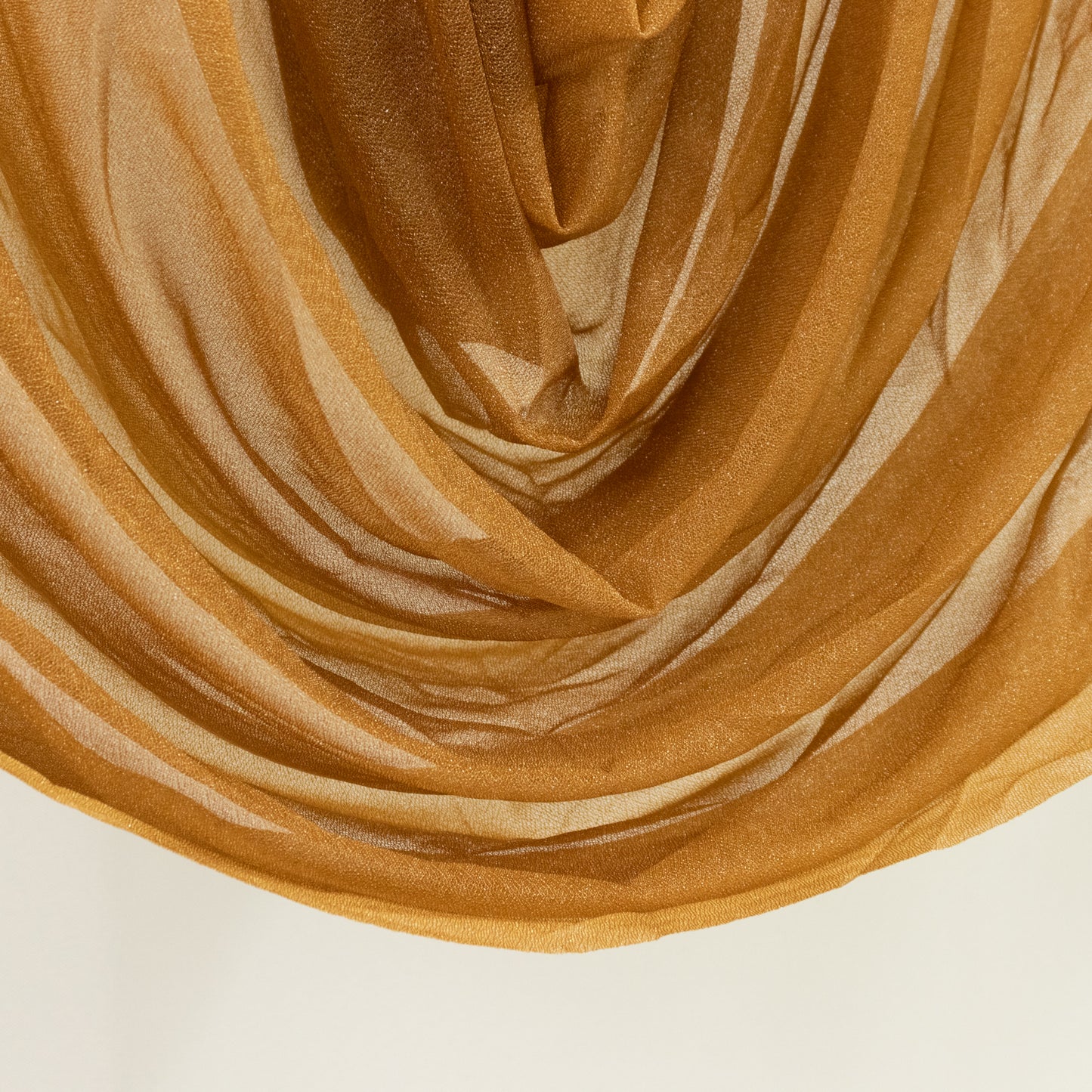 Gold sheer chiffon valance curtain draped elegantly.