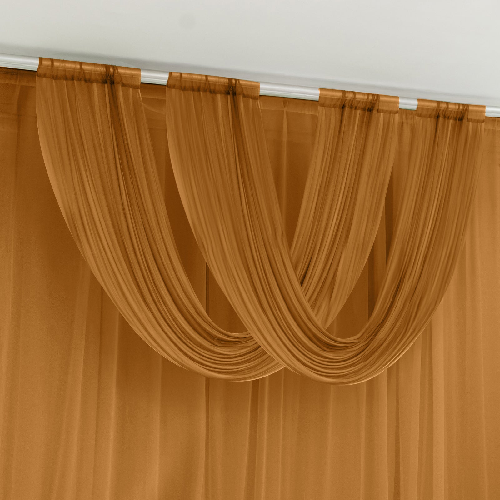 Gold sheer chiffon valance curtain draped elegantly.