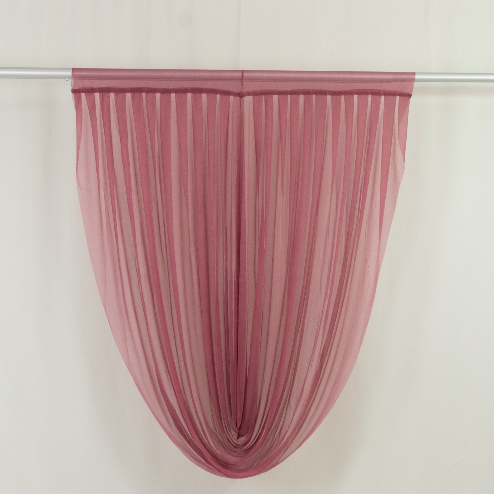 Mauve sheer chiffon valance curtain draped elegantly on a rod.