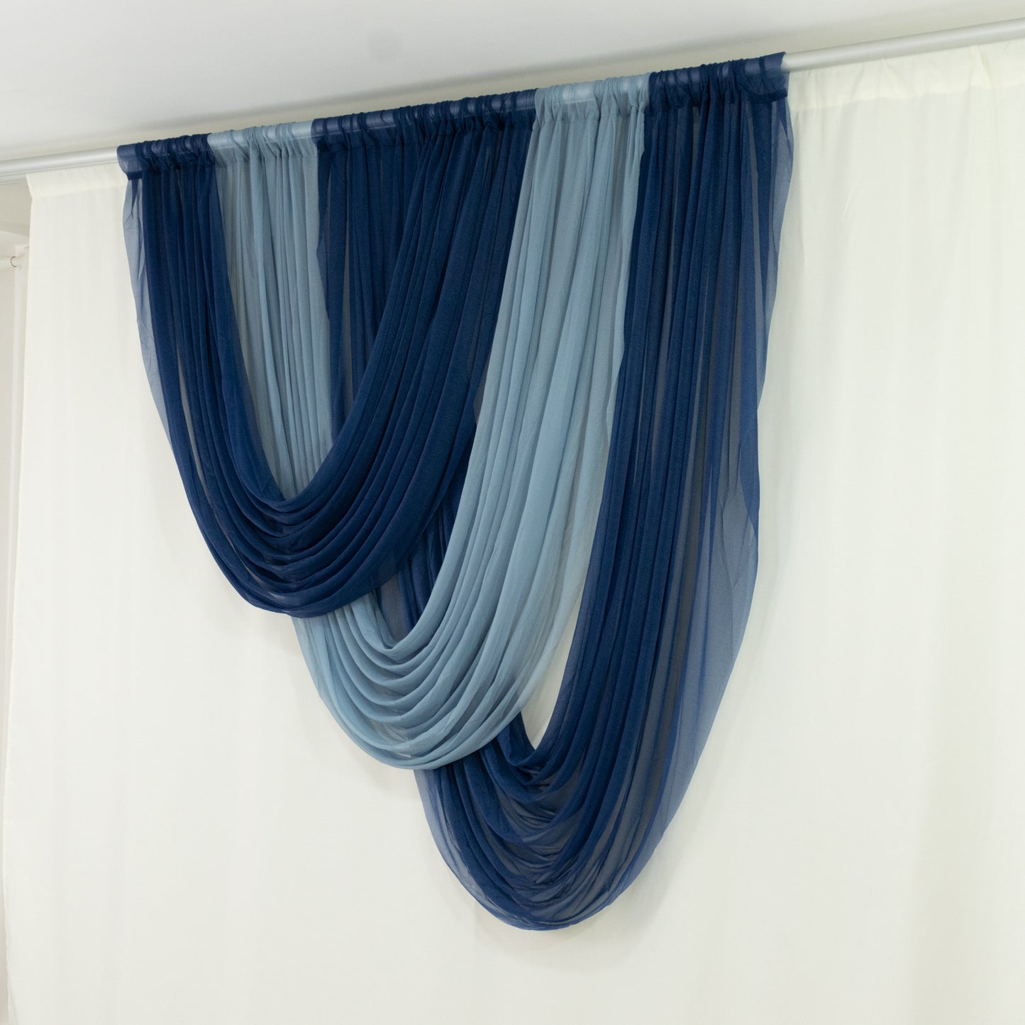 Navy blue sheer chiffon valance curtain draped elegantly on a white backdrop.