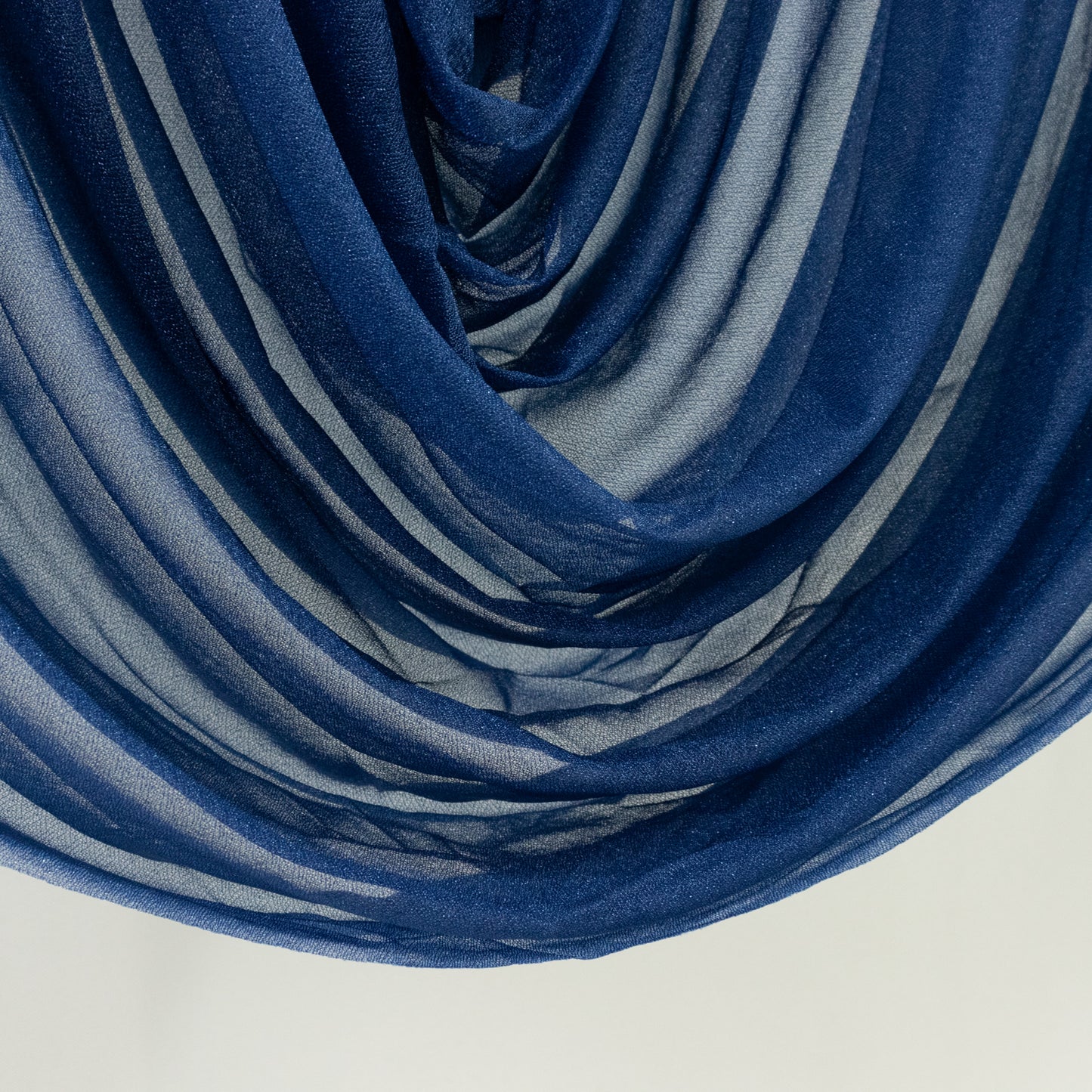 Navy blue sheer chiffon valance curtain drape for wedding arch decor.