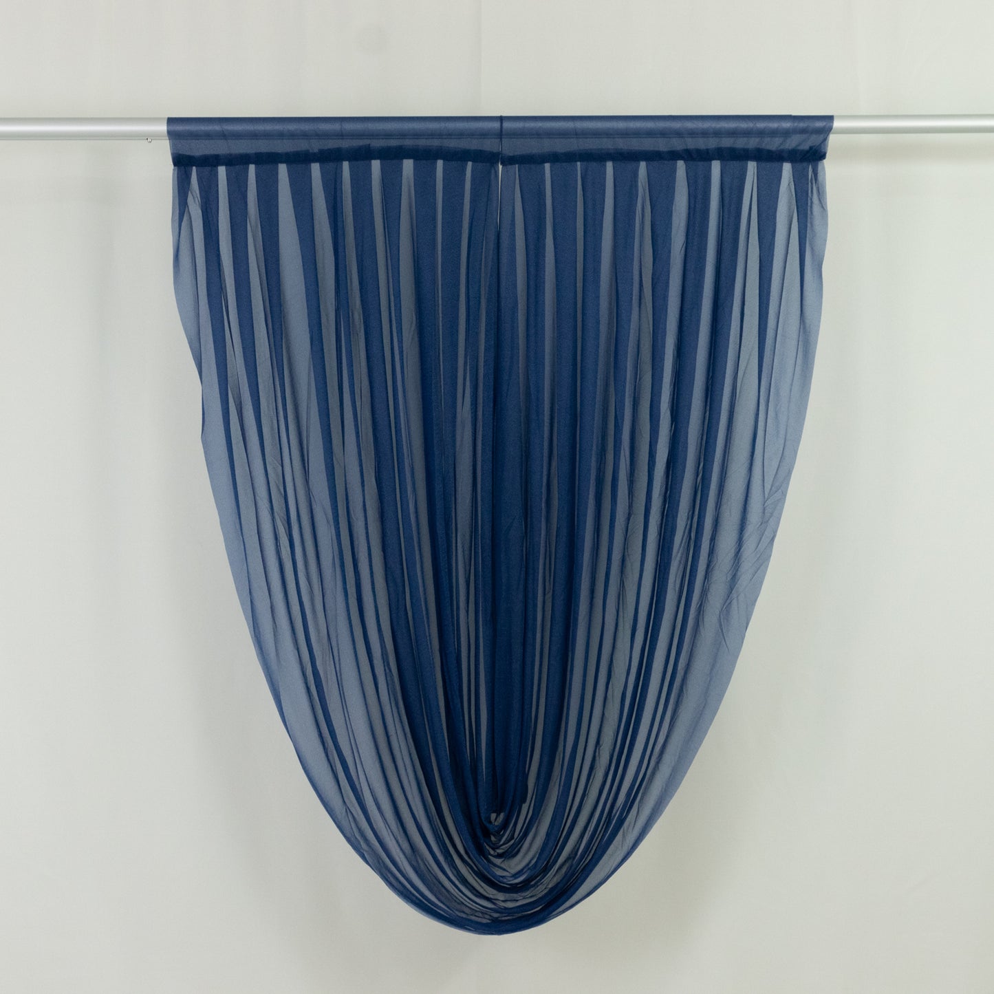 Navy blue sheer chiffon valance curtain draped elegantly.