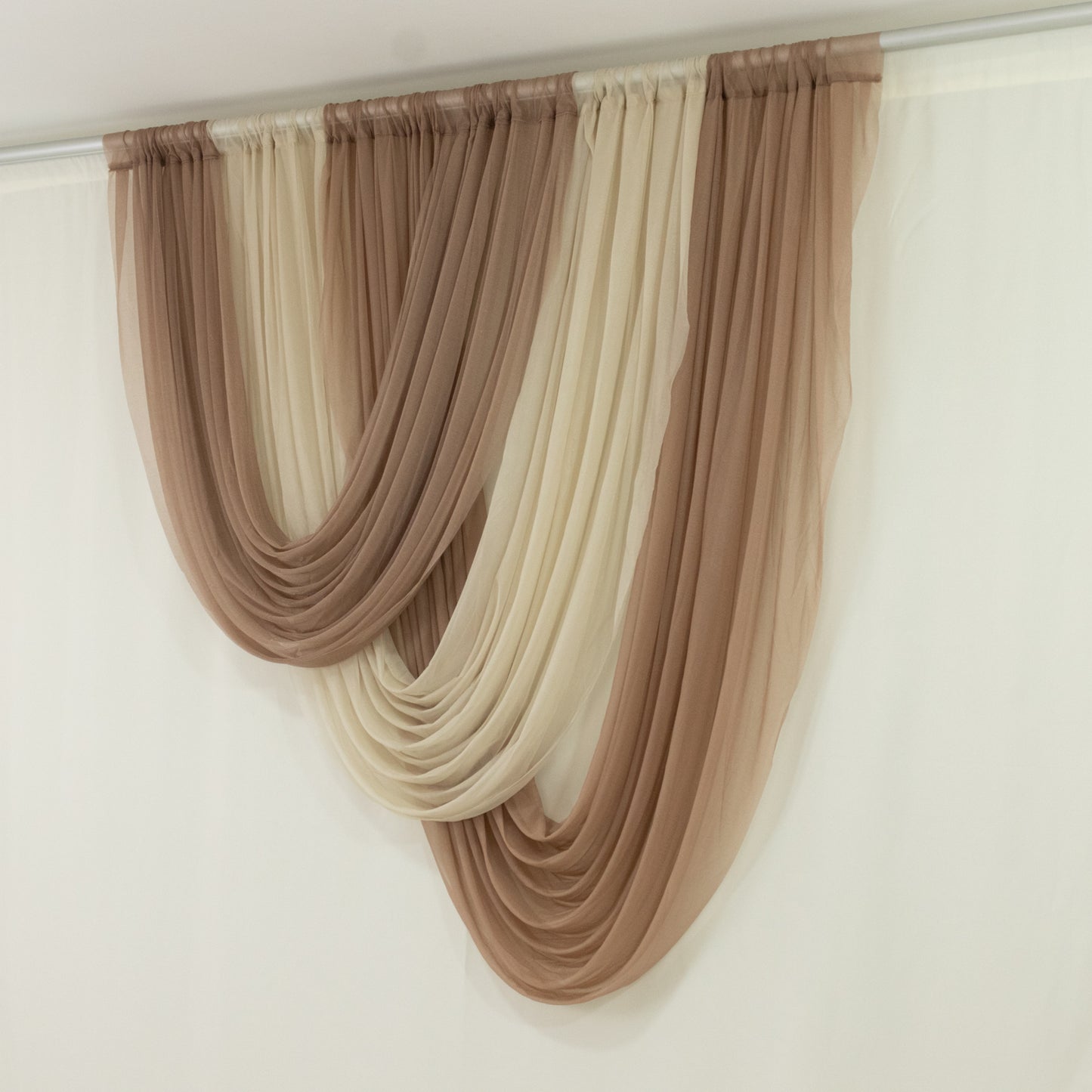 Taupe sheer chiffon curtain draped elegantly for wedding decor.