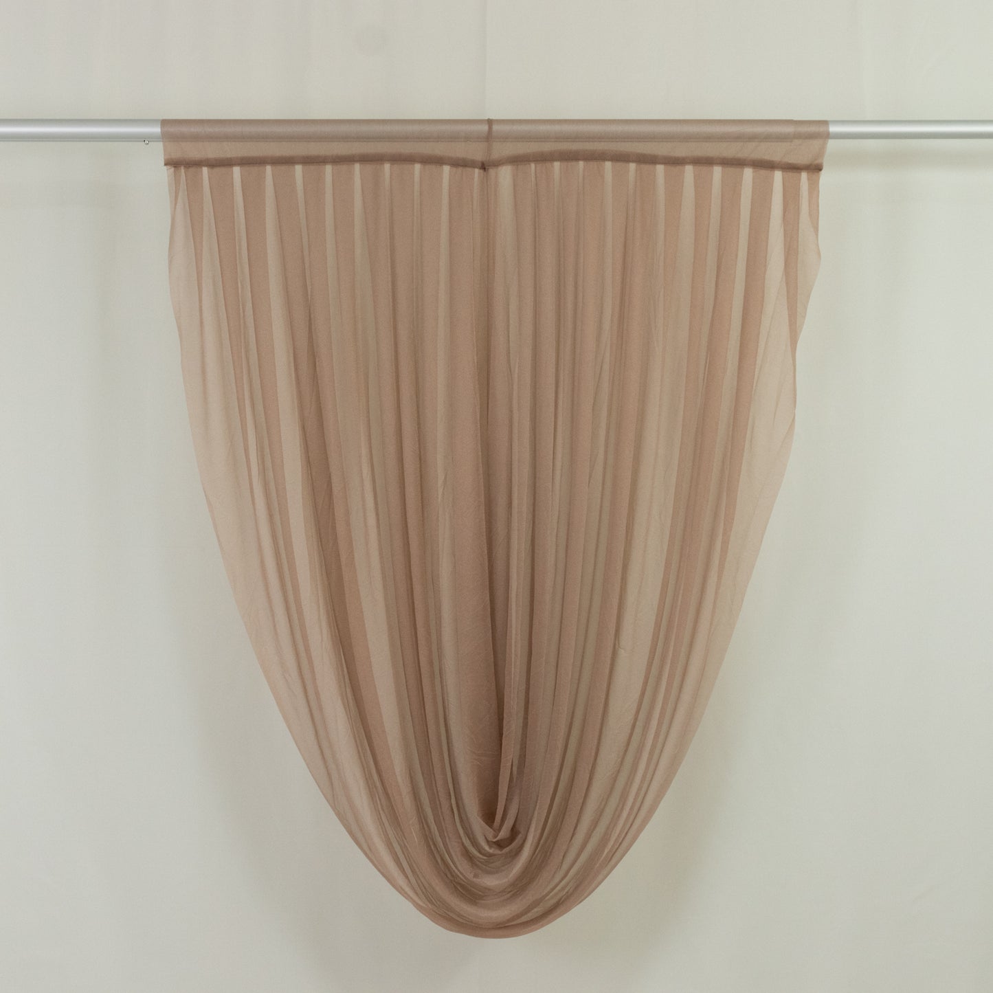 Taupe sheer chiffon valance curtain draped elegantly on a rod.