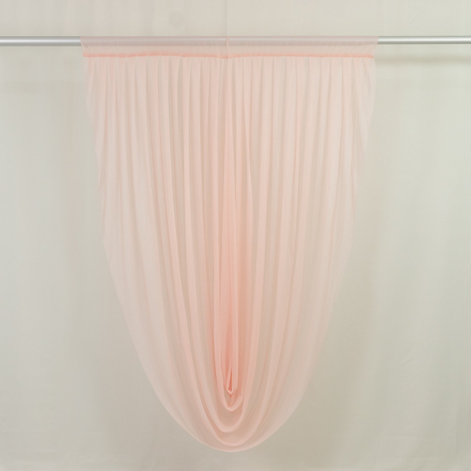 Blush draped sheer fabric for elegant home decor and event styling.