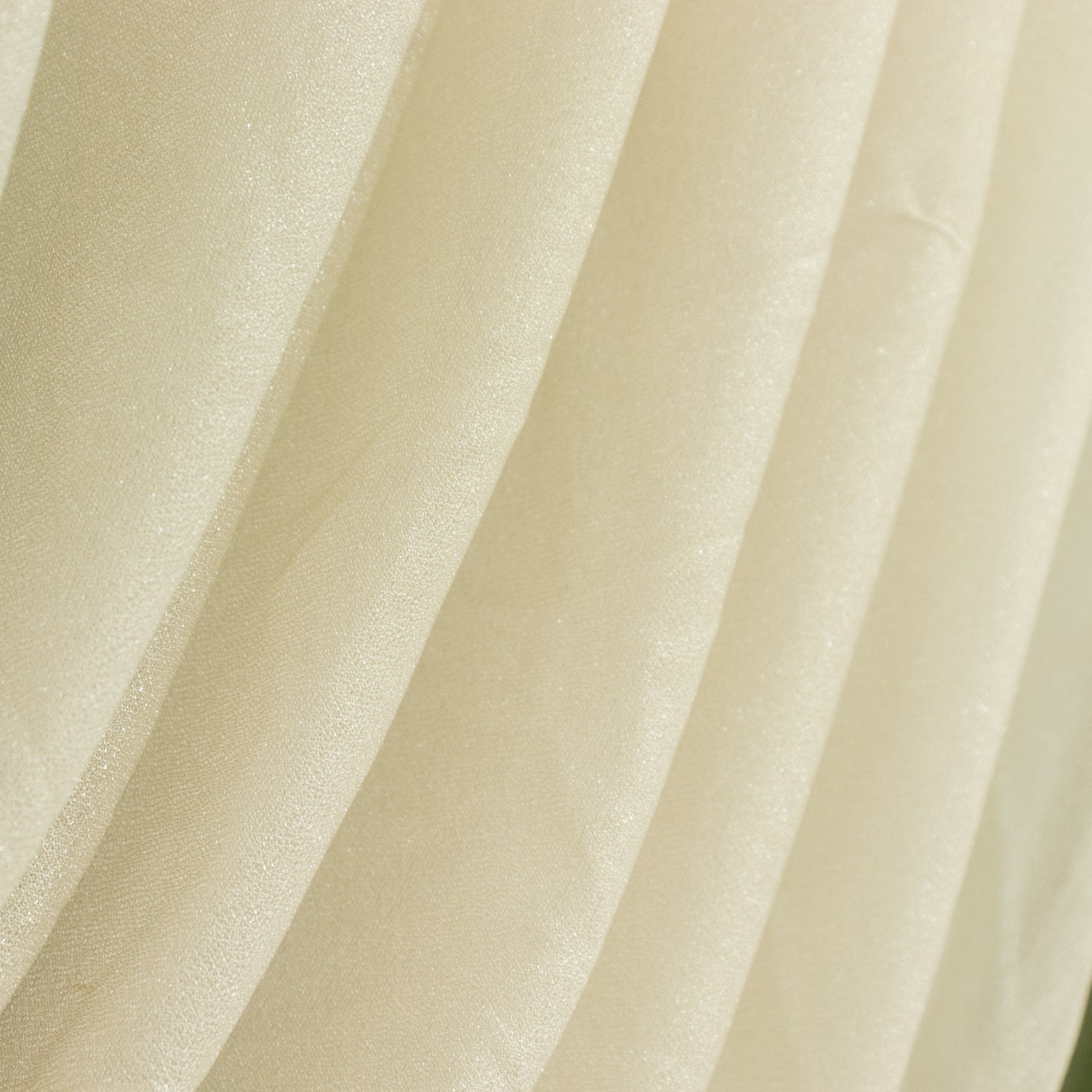 Beige shimmering fabric drapes with soft