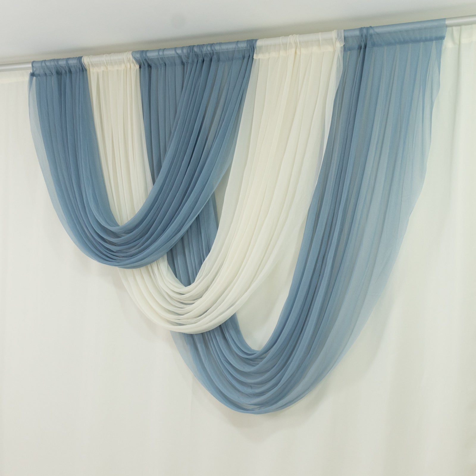 Dusty blue and white sheer curtains draped elegantly in a modern setting.