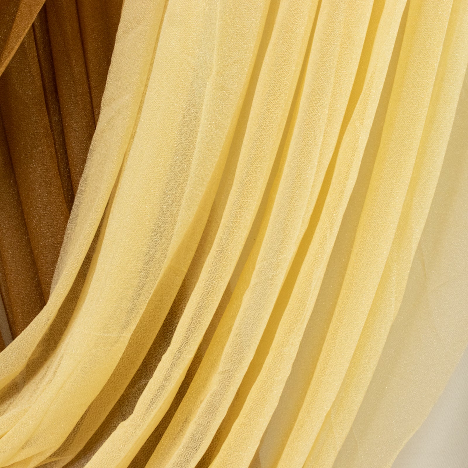 Champagne sheer chiffon valance curtain drape in elegant flowing fabric.