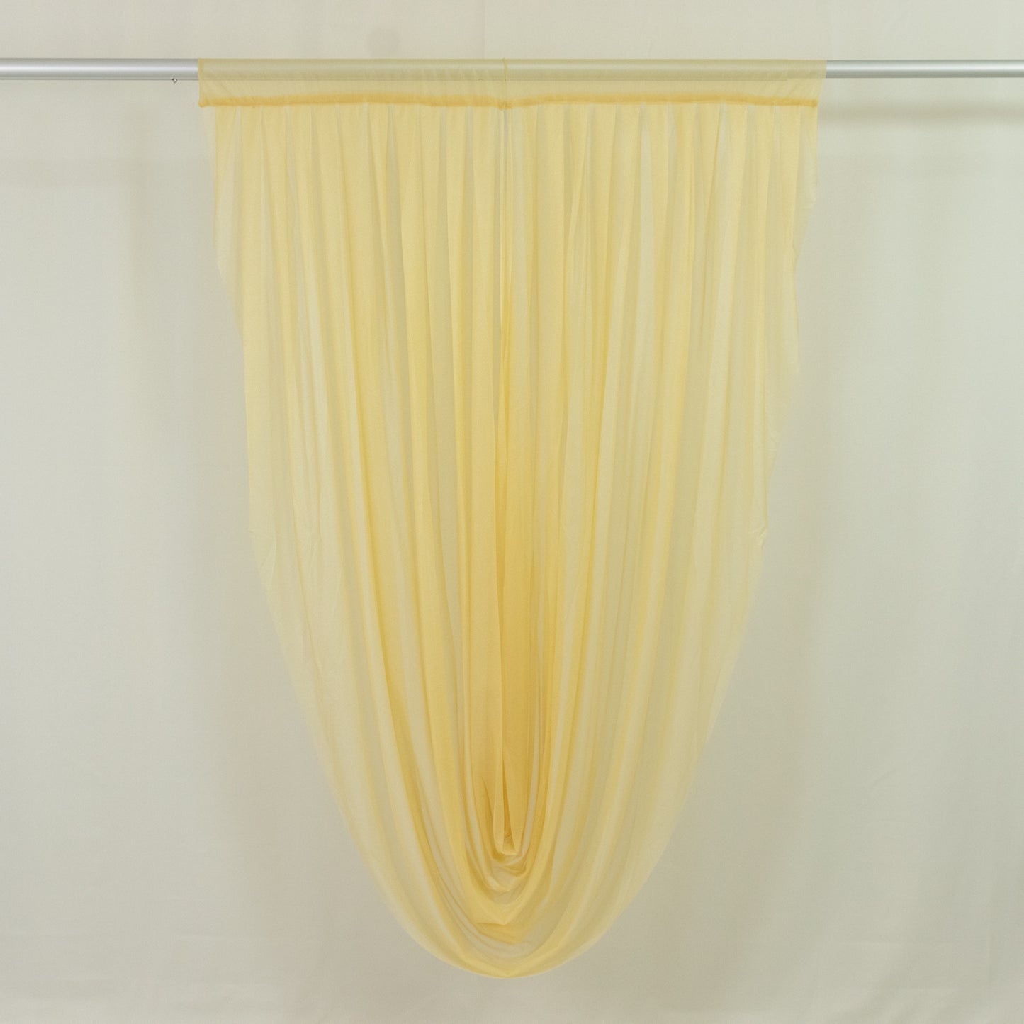 Champagne sheer chiffon valance curtain draped elegantly.