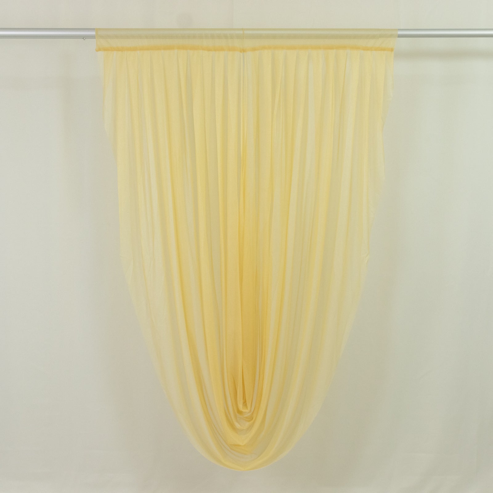 Champagne sheer chiffon valance curtain draped elegantly.