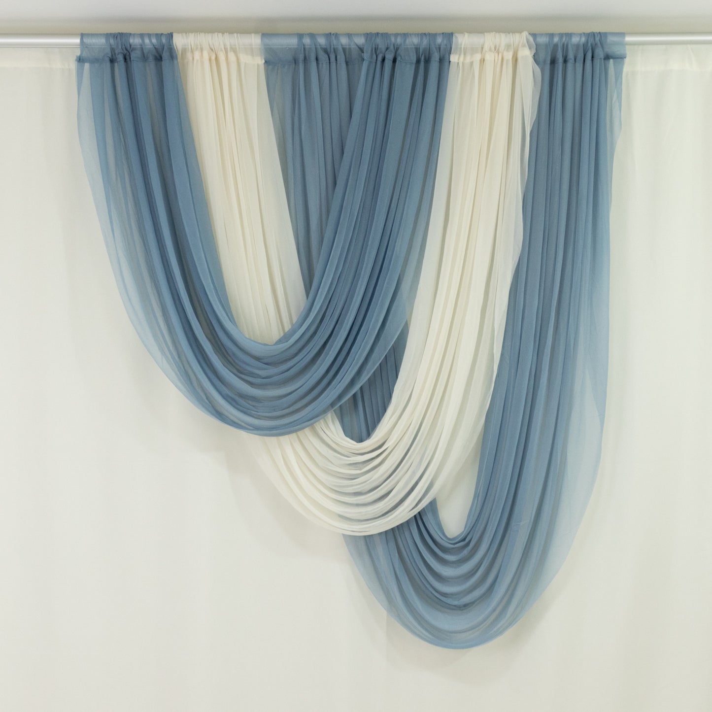 Ivory and blue sheer chiffon valance curtain draped elegantly.