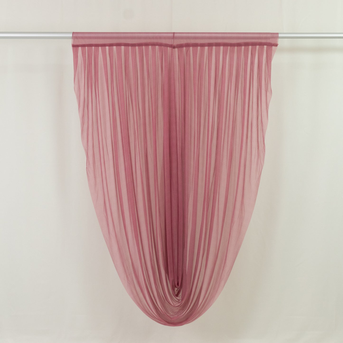 Mauve sheer chiffon valance curtain draped elegantly on a rod.
