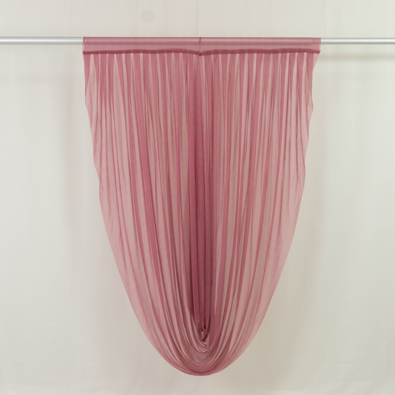 Mauve sheer chiffon valance curtain draped elegantly on a rod.
