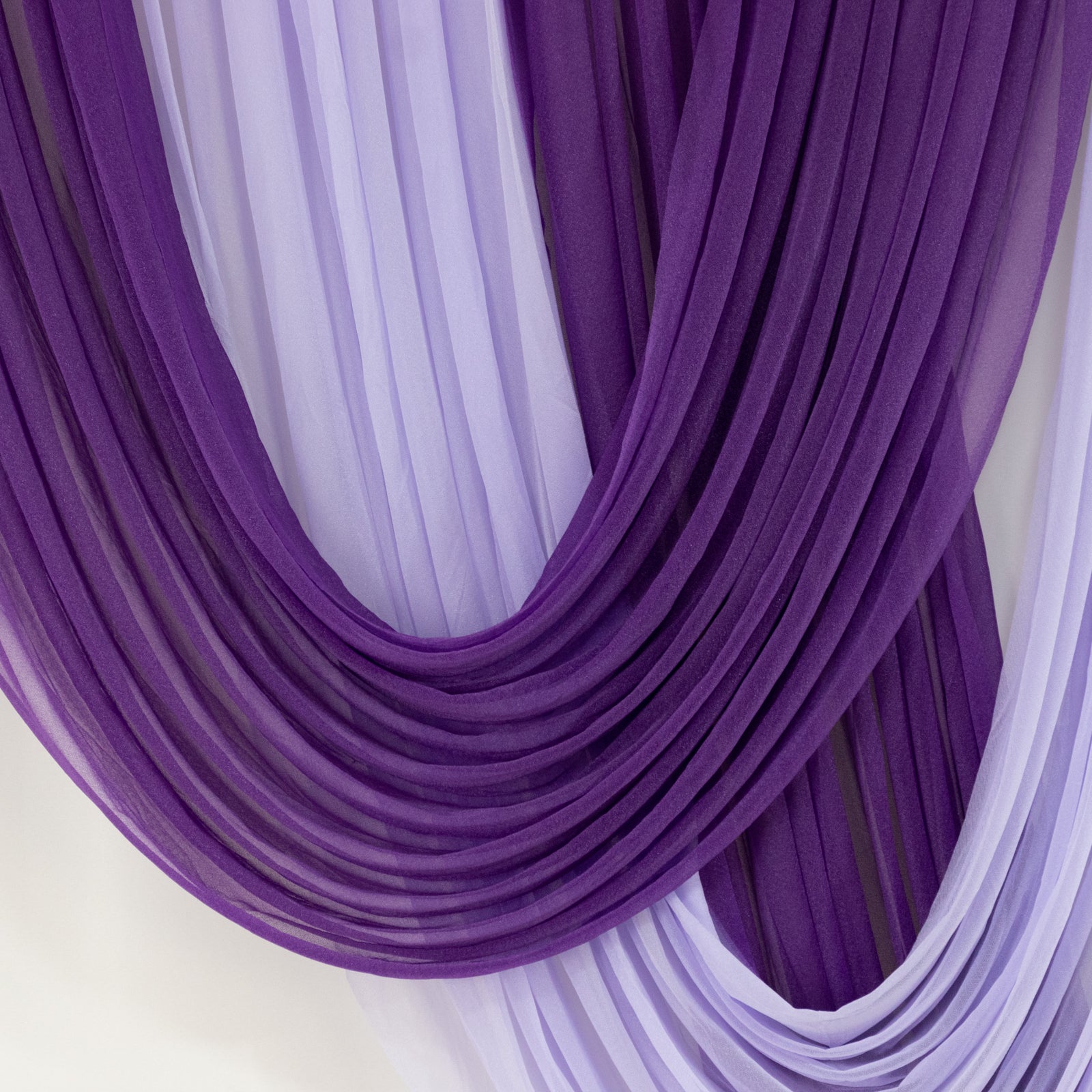 Purple sheer chiffon valance curtain draped elegantly for weddings.