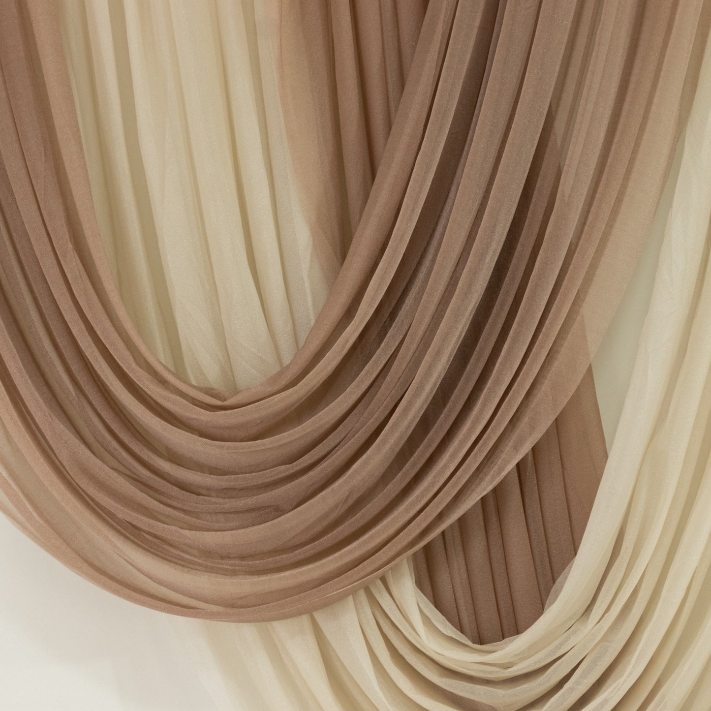Taupe sheer chiffon valance curtain draped elegantly.