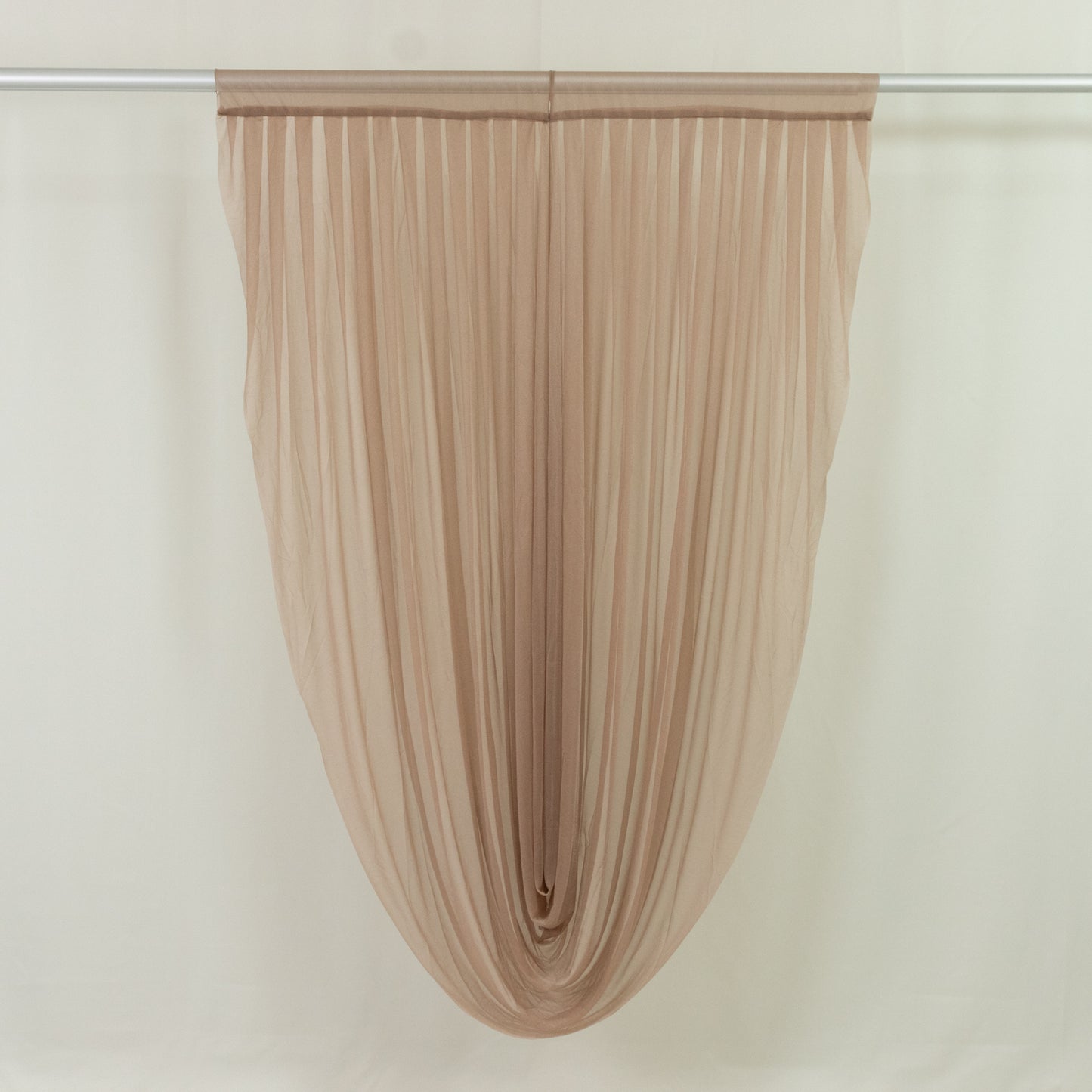 Taupe sheer chiffon valance curtain draped elegantly on a rod.