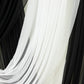 White sheer fabric draped alongside black tulle for elegant decor accents.