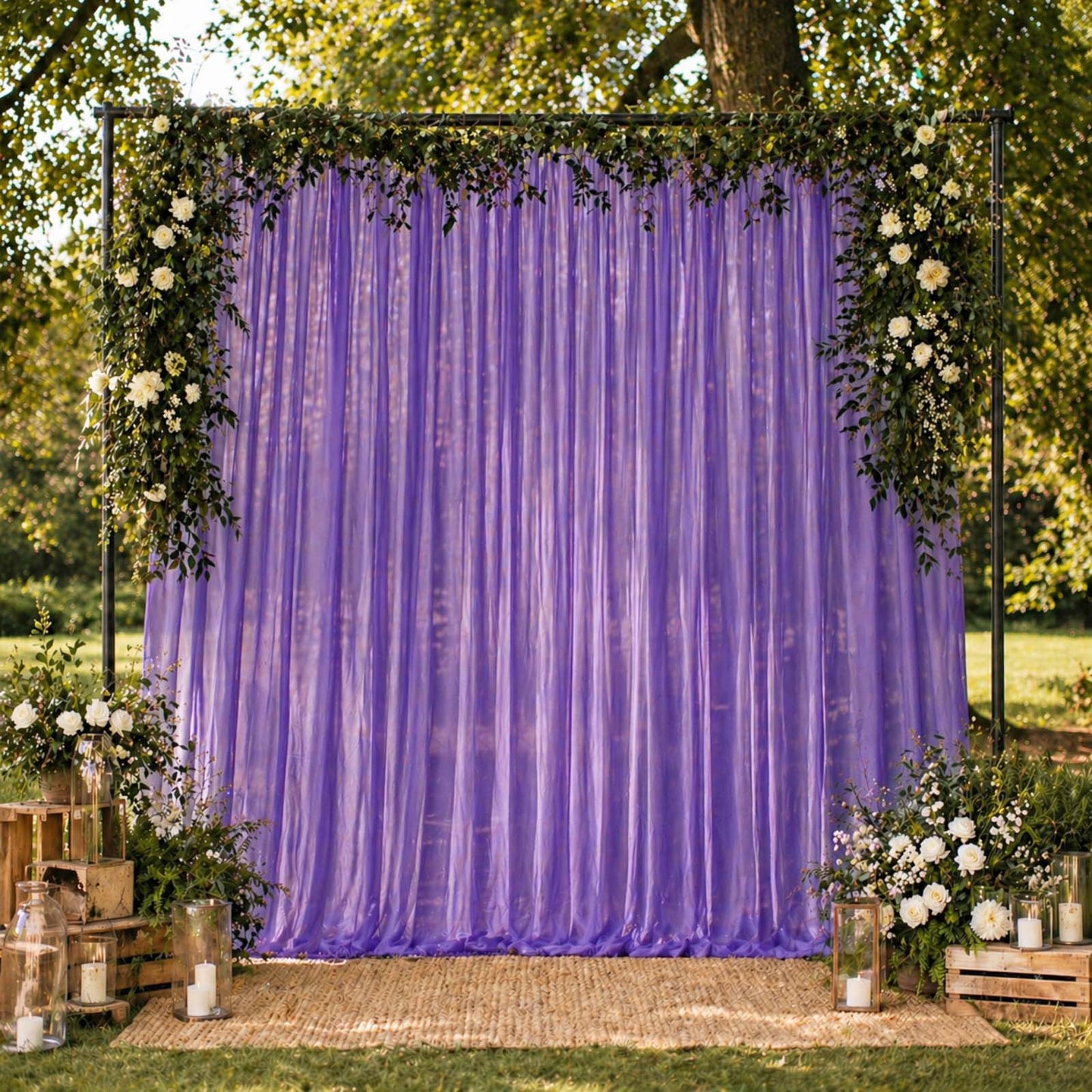 Purple chiffon backdrop curtain panel draping with floral decor.