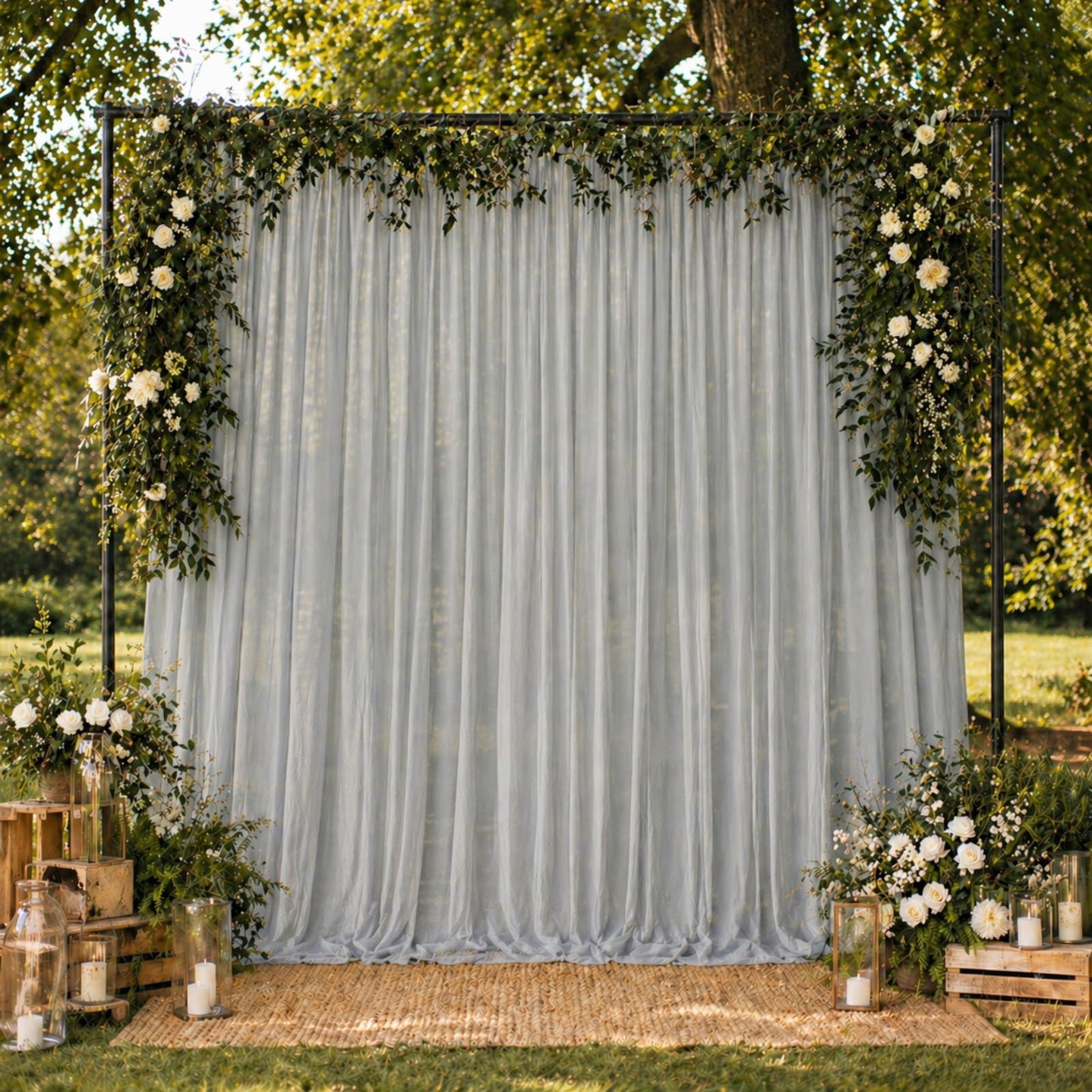 Silver chiffon backdrop curtain panel draped elegantly with floral decor.
