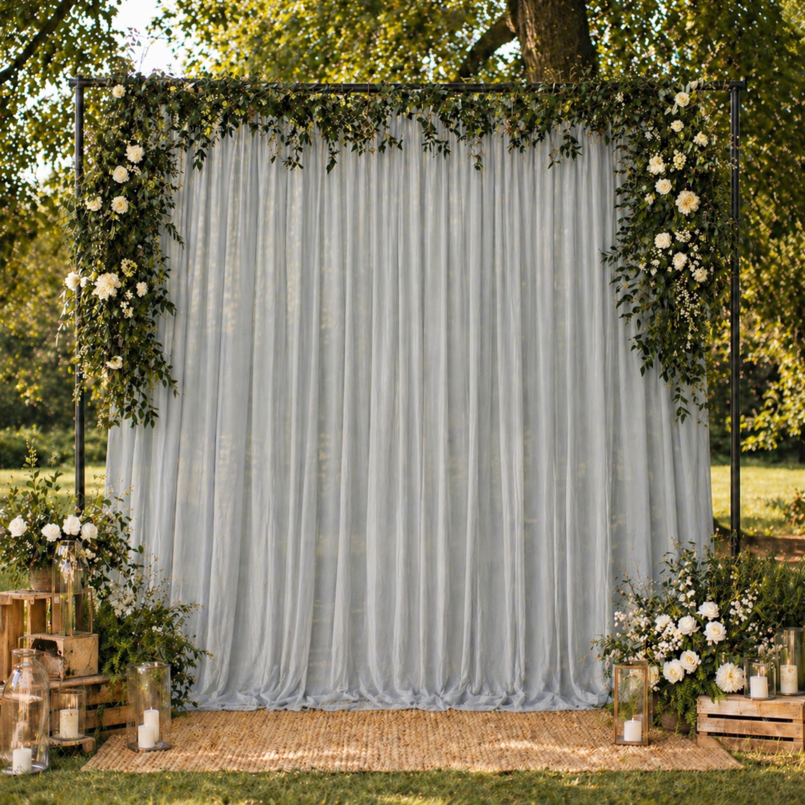 Silver chiffon backdrop curtain panel draped elegantly with floral decor.